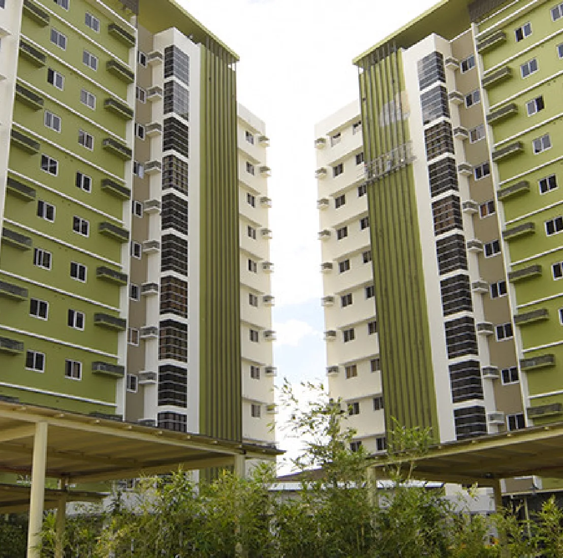 Exterior view looking up between the two green-accented Midori Residences towers